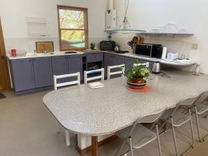 a kitchen with a table and chairs in a kitchen at lagoon Breeze in Langebaan +11 photos