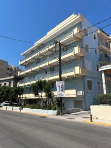 a large apartment building with a sign in front of it at Bella Vista Apartment in Chios