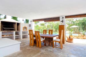 a dining room with a wooden table and chairs at Classic Villa for 12- Pool, BBQ, big exterior area in Illes Balears