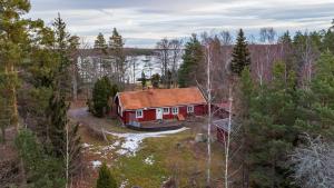 an aerial view of a red house in the woods at Hus Skärgården in Figeholm