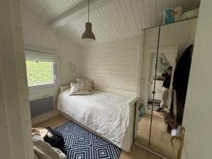 une petite chambre avec un lit et un miroir dans l'établissement Coast Seven, à Borgwedel