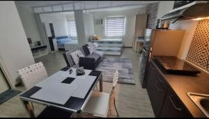 a kitchen and a living room with a table and chairs at Joms Cozy Staycation in Calamba
