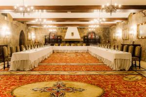 a banquet hall with tables and chairs in a room at Hotel Fortaleza do Guincho Relais & Châteaux in Cascais