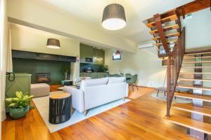 a living room with a couch and a staircase at Hotel Quinta Do Furao in Santana