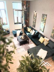 a living room with a couch and a table at VOK Luxury Home I Tropical Living in Arad