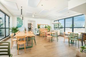 a dining room with tables and chairs and windows at Dotcampus Roma City Center in Rome