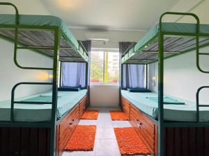 two bunk beds in a room with a window at Hostel at Galle Face in Colombo