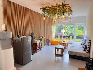 a living room with a refrigerator and a couch at Hostel at Galle Face in Colombo