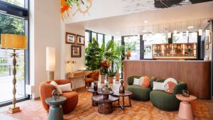 a lobby with two couches and a bar at Residhome Quai d’Ivry in Ivry-sur-Seine
