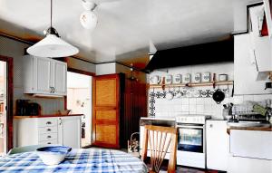 a kitchen with a table and a stove top oven at 4 Bedroom Stunning Home In Ryd in Ryd