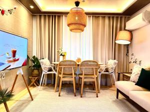 a living room with a dining room table and chairs at Gangseo House in Seoul