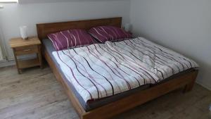 a bed with two pillows on it in a bedroom at Das Landhaus Wohnung 1 in Kirch Mulsow