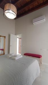a bedroom with a large bed and a red bench at Sherryflat Jerez Centro in Jerez de la Frontera +46 photos