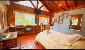 a bedroom with a large bed in a room at Cabaña La iluminada in Tandil