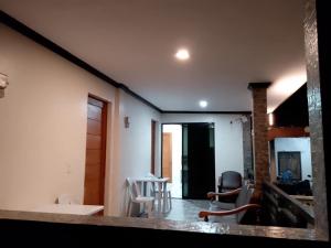 a kitchen and living room with a table and chairs at K.Y.M Pension House in Moalboal