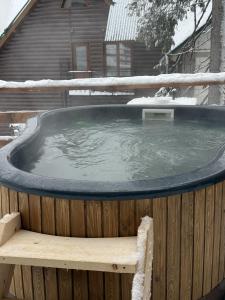 a hot tub with snow on top of a wooden fence at Маріна Драгобрат in Dragobrat