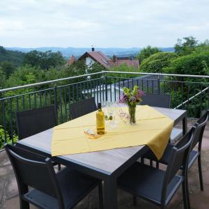 a table with a yellow table cloth on a balcony at Villa Christina in Lindenfels