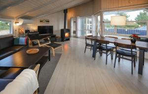 a living room with a table and chairs and a couch at Klitbo in Rømø