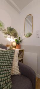 a bedroom with a bed and a mirror on the wall at A L'ombre des Pins, Appartement neuf, élégant, Parking gratuit, Netflix, au calme à 100m de l'océan in Les Sables-dʼOlonne