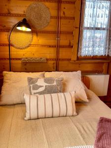 a bedroom with a bed in a wooden wall at PEŁNA CHATA w Gródku nad Dunajcem in Gródek Nad Dunajcem