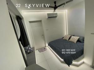 a small bedroom with a bed and a mirror at 22 Skyview in Bukit Mertajam