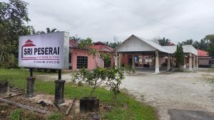 a sign in front of a building at Sri Peserai homestay in Batu Pahat