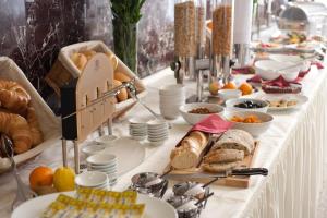 a buffet of bread and pastries on a table at Hotel Unique Majestic in Dortmund