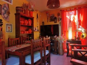a dining room with a table and a television at El REFUGIO DE KARIM in San Rafael