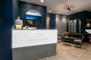 a reception desk with a mirror and a chair at Cesare ai Cavalieri Suites in Rome