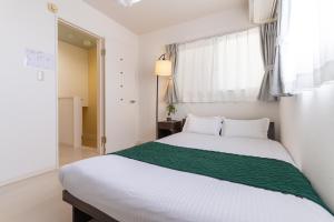 Postel nebo postele na pokoji v ubytování 年末年始特別割引 無料 駐車 4ldk戸建 関空 難波 心斎橋 通天閣 スパワールド世界の大温泉 天王寺動物園 京都直通 天下茶屋駅徒歩5分