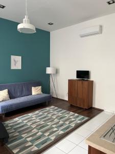 a living room with a couch and a tv at GRACIA APARTMENT HOUSE in Budapest