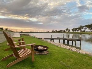 a bench and a fire pit next to a dock at Casa Carrera in Wellington East