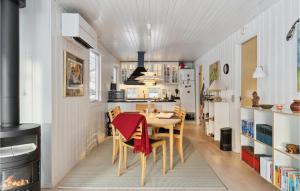 a dining room with a table and a kitchen at 4 Bedroom Gorgeous Home In Hornbæk in Hornbæk