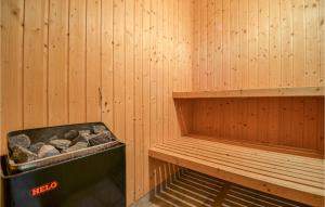 a sauna with a bench and a trash can at Holiday Home Ravnsvej Ebeltoft Denm in Ebeltoft
