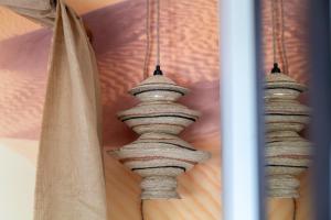 a group of three vases hanging from a curtain at La Caravane du Touareg in Juan-les-Pins