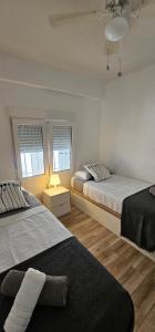 A bed or beds in a room at APTO TANEZ TORREMOLINOS, a