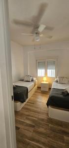 A bed or beds in a room at APTO TANEZ TORREMOLINOS, a