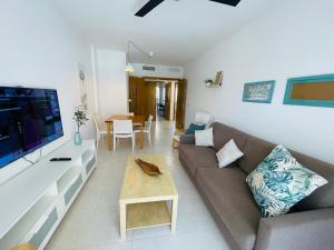 a living room with a couch and a table at Jardines de Veneciola by Alina365 in La Manga del Mar Menor