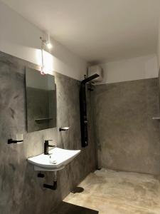 a bathroom with a sink and a mirror at Ruvee Villa in Weligama