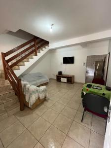 a room with a staircase and a bed and a tv at Recanto dos Sonhos in Vargem +20 photos