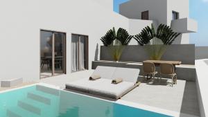 a living room with a bed and a swimming pool at Kalimera Karpathos Exclusive Villas in Afiartis