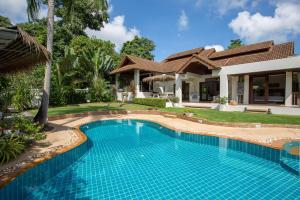 a swimming pool in front of a house at Baan Lily in Chaweng