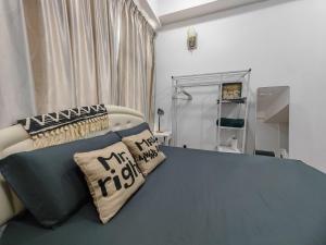 a bedroom with a bed with pillows on it at Suite U Studio D'Perdana Wifi Netflix in Kota Bharu +6 photos