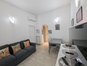 a living room with a couch and a table at Il Centro in Camaiore
