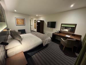 a hotel room with a bed and a desk at Hotel Nineteen in Barnsley