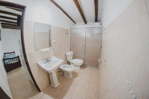 a bathroom with a toilet and a sink and a shower at Complejo Heliópolis in Piriápolis +44 photos