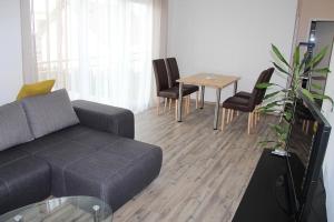 a living room with a couch and a table with chairs at Casa Helvetia in Rheinhausen