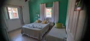 Cama ou camas em um quarto em Pousada Irashai