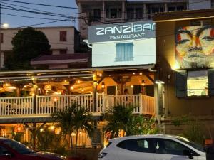 a building with a sign on the side of it at Le Ti Marinois 5 in Le Marin