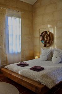 a bedroom with a bed with two towels on it at Mas de l'Hermitage in Moulès